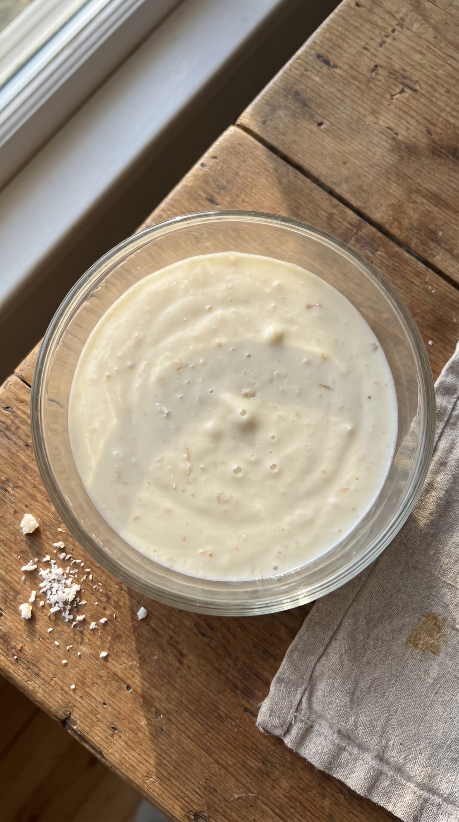 A creamy white chocolate coconut mousse served in a glass and topped with coconut.